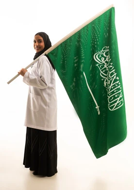 Saudi Female Doctor Holding Saudi Flag in Studio