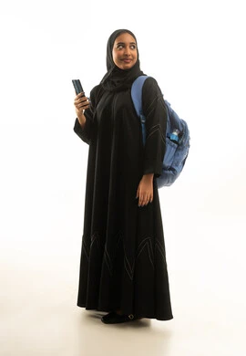 Saudi Female Student with Backpack and Smartphone
