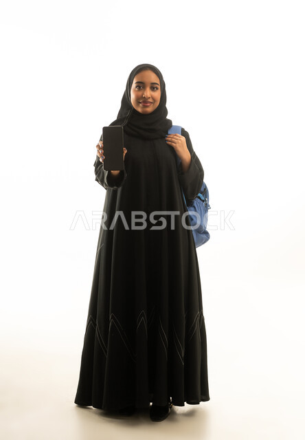Saudi Female Student Holding Smartphone with Backpack