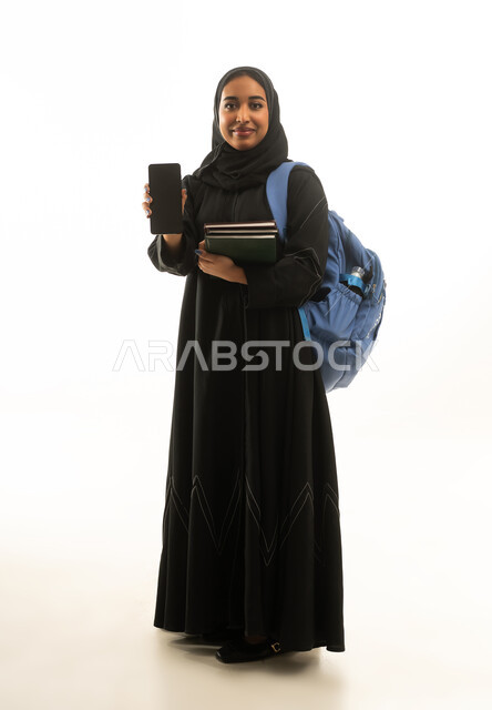 Saudi Female Student with Smartphone and Books