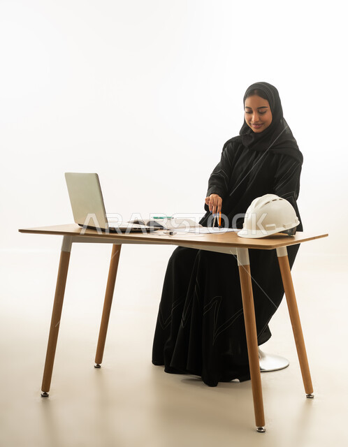 Saudi Female Engineer Working at Office Desk