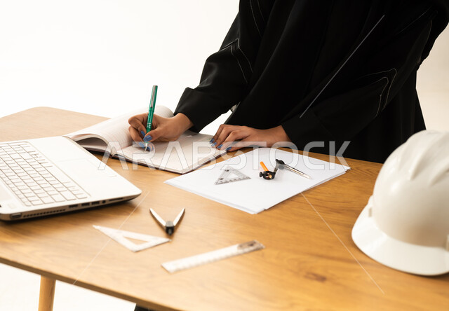 Saudi Female Engineer Working at Office Desk