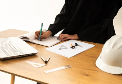 Saudi Female Engineer Working at Office Desk