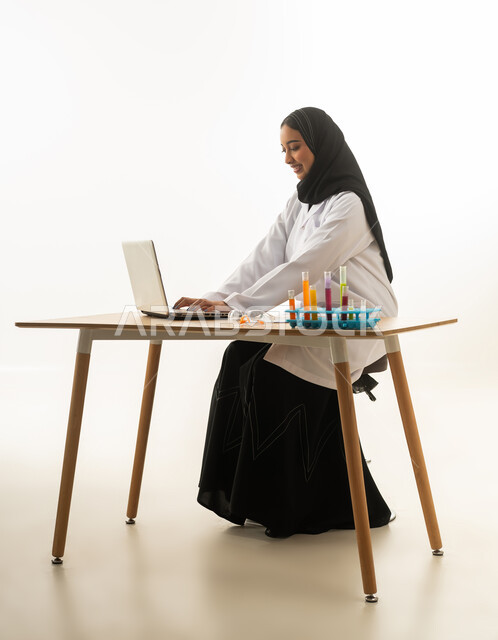 Saudi Female Scientist Working on Laptop in Lab