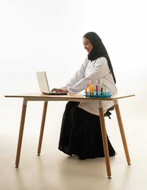Saudi Female Scientist Working on Laptop in Lab