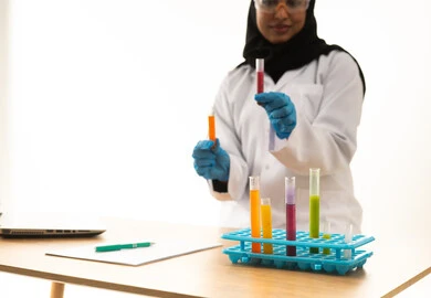 Saudi Female Scientist with Test Tubes in Laboratory