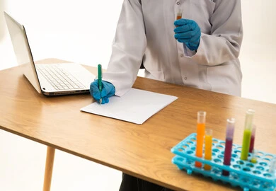 Scientist in Lab Coat Writing Research Data