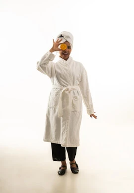 Saudi Woman in White Bathrobe with Orange Slice