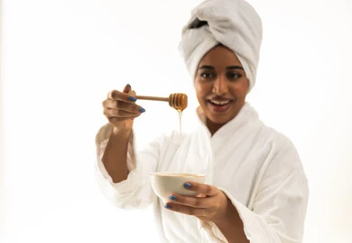 Saudi Woman in White Bathrobe with Honey Dipper
