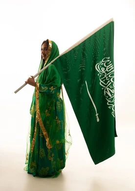 Saudi Woman Holding National Flag in Traditional Dress