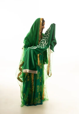 Saudi Woman in Traditional Green Dress with National Flag