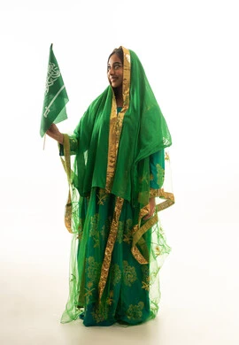 Saudi Woman in Traditional Green Dress Holding National Flag
