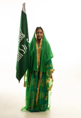 Saudi Woman with National Flag in Traditional Dress