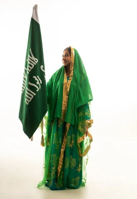 Saudi Woman in Traditional Nashal Dress Holding Flag