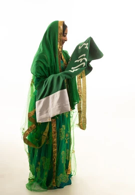 Saudi Woman in Traditional Nashal Dress Holding Flag