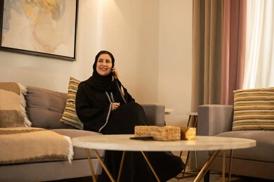 Saudi Woman in Abaya Talking on Landline Phone