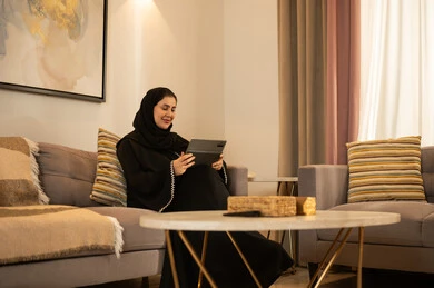 Saudi Woman Using Tablet in Modern Living Room