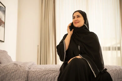 امرأة سعودية تتحدث عبر الهاتف في غرفة النوم