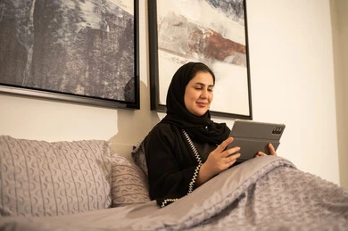 Saudi Woman Using Digital Tablet in Modern Bedroom Saudi Woman Using Digital Tablet in Modern Bedroom