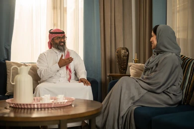 Saudi Man and Woman Talking in Living Room