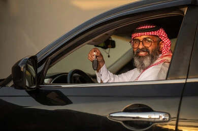 Saudi Man Holding Car Key Inside Vehicle at Sunset