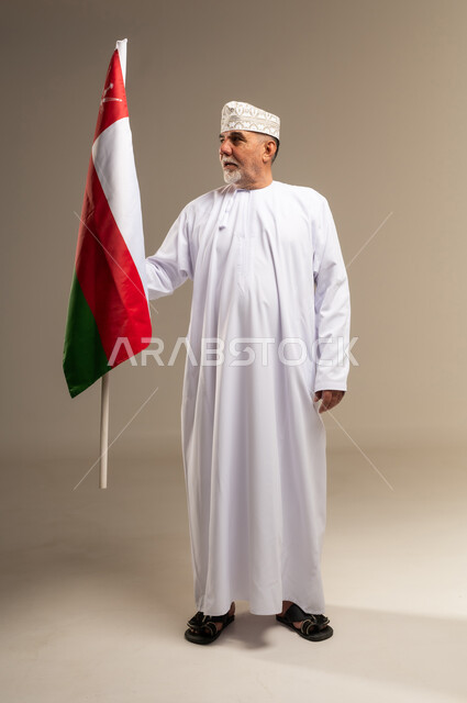 Senior Omani Man Holding Oman National Flag