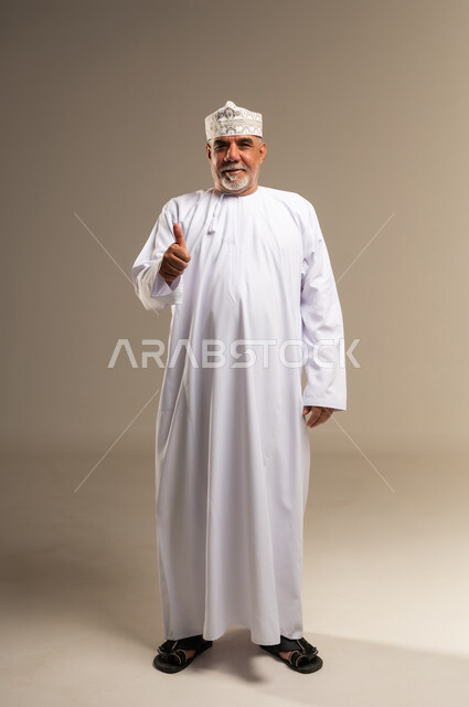 Omani Man in Traditional Dishdasha Giving Thumbs Up