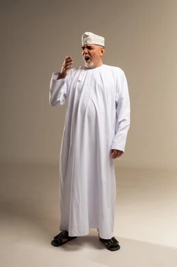 Senior Omani Man Yawning in Traditional White Dishdasha