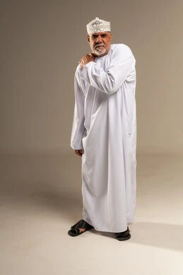 Omani Man in Traditional Dress with Shoulder Pain
