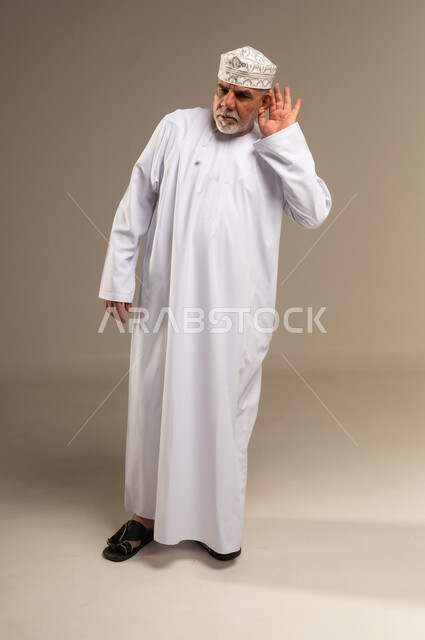 Elderly Omani Man in Traditional Dress Listening