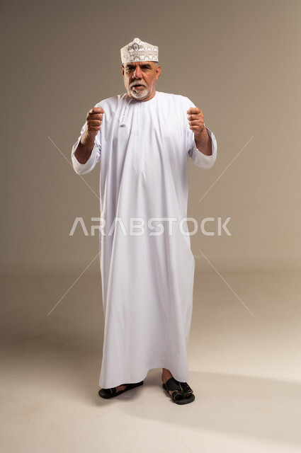 Elderly Omani Man in Traditional Dishdasha and Kumma
