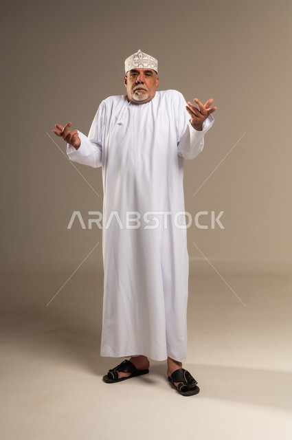 Omani Senior Man Shrugging in Traditional Dishdasha