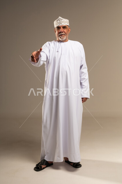 Senior Omani Man Offering Handshake in Traditional Dress