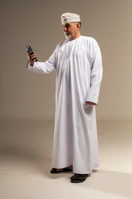 Omani Senior Man Using Smartphone in Studio