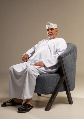 Elderly Omani Man Sitting in Traditional Dress