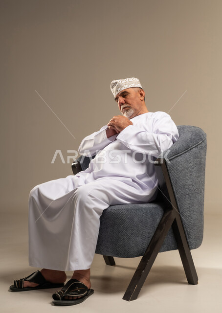 Elderly Omani Man Resting in Armchair Studio Portrait