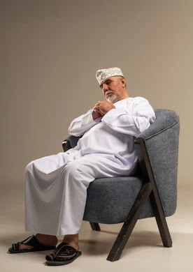 Elderly Omani Man Resting in Armchair Studio Portrait