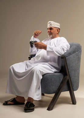 Senior Omani Man Playing Video Games in Studio