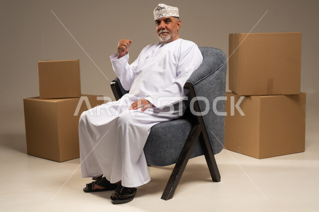 Senior Omani Man with Cardboard Boxes in Studio