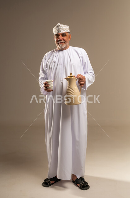 Omani Man in Traditional Dress with Coffee Dallah
