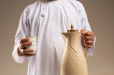 Arab Man in White Kandura Holding Coffee Dallah