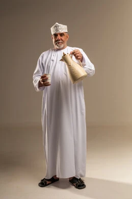 Omani Man in Traditional Dress with Arabic Coffee Pot