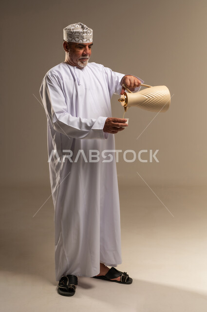 Omani Man Pouring Traditional Arabic Coffee in Studio