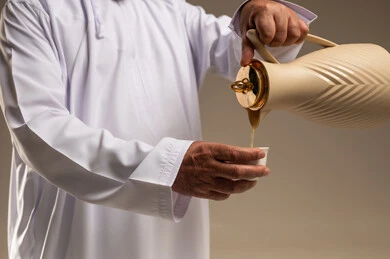 Emirati Man Pouring Arabic Coffee in Studio