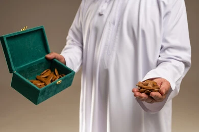 Saudi Man Holding Agarwood Bakhoor in Green Box