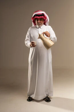 Saudi Senior Man Pouring Traditional Arabic Coffee