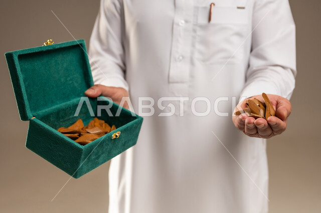 Saudi Man Holding Traditional Agarwood Oud Chips