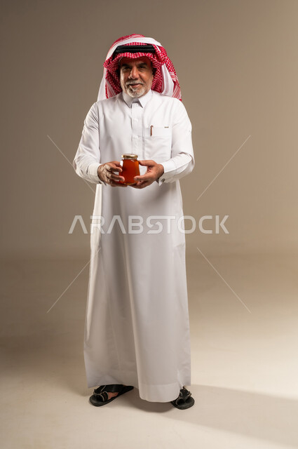 Saudi Senior Man Holding Jar of Natural Honey