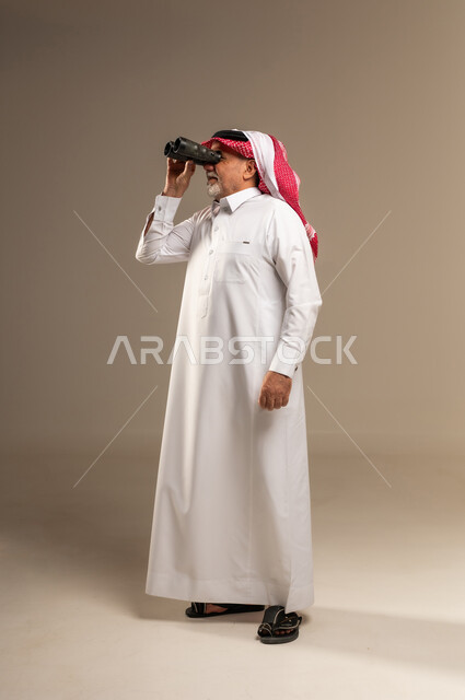 Elderly Saudi Man with Binoculars in Studio