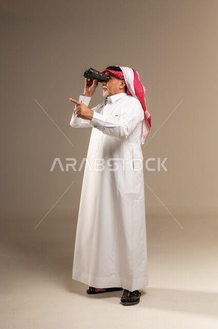 Senior Saudi Man with Binoculars in Studio